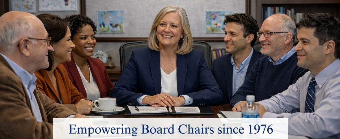 School board meeting with trustees smiling and board chair at the head of the table.